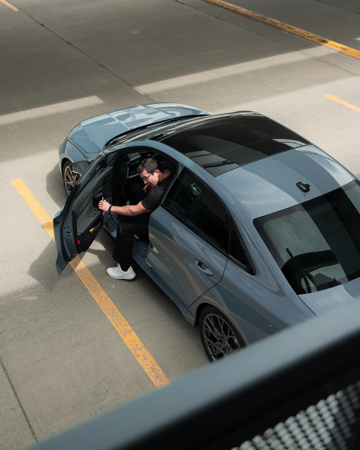 Overhead view of the Audi RS3 with the driver stepping out