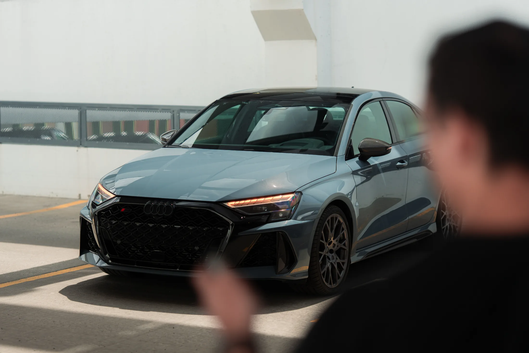 2026 Audi RS3 front three-quarter view in a bright parking structure